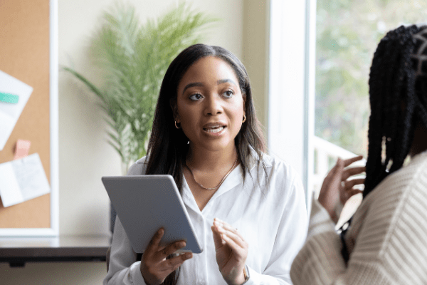 A salesperson speaking to a woman to help her find the right solutions to her problems
