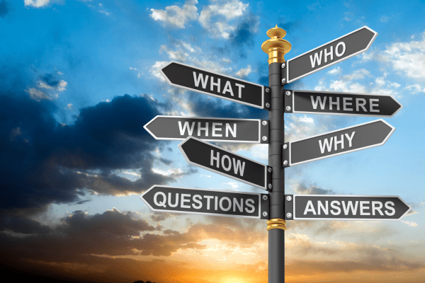 A sign with pointers for who, what, where, when, why, how, questions, and answers