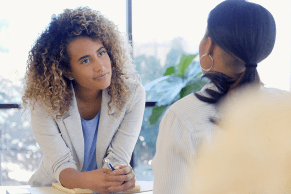 Woman listening to another woman during a warm, deep conversation